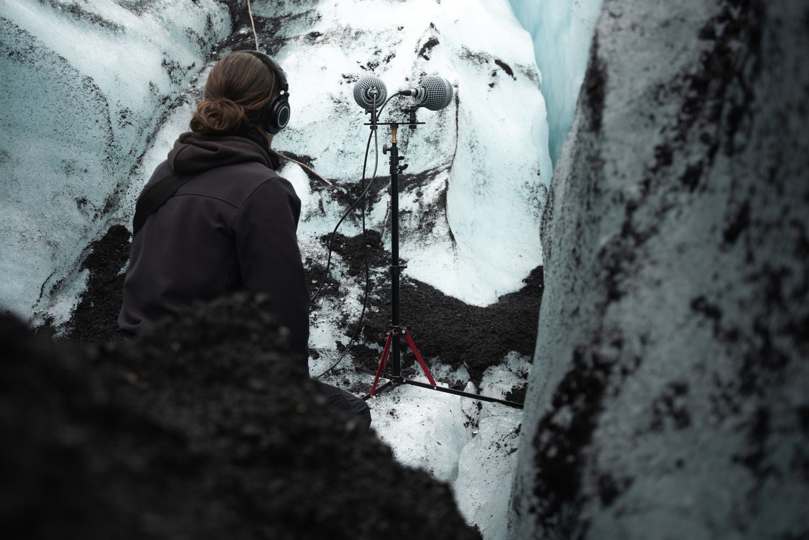 Field recordist listening to a glacier through a pair of LOM microphones