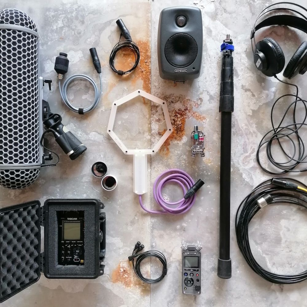 Recorders, microphones, cables and headphones from the LOM rental laid out on a table